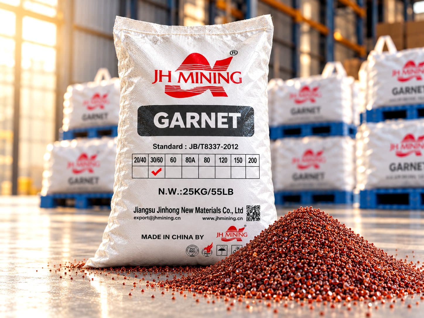 A 25 kg bag of garnet abrasive beside loose granules